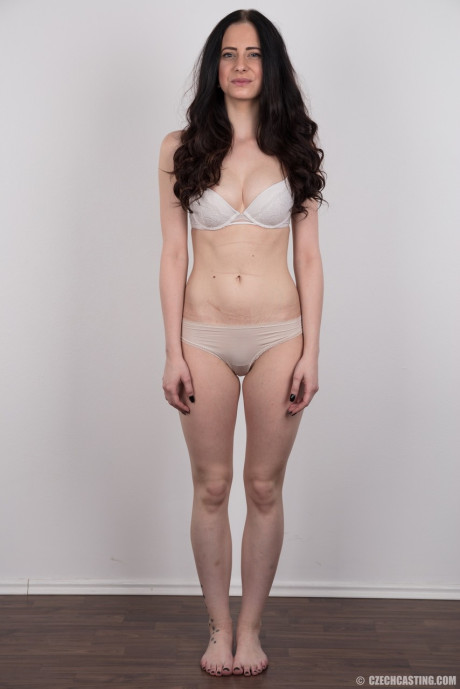Dark haired female with a firm face model in the undressed for the first time