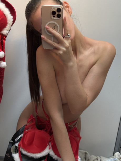 Brunette whore broad goes bare-breasted while taking mirror selfies at Christmas