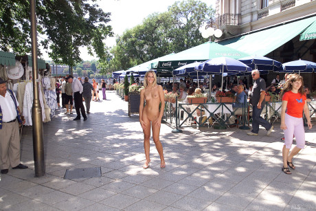 Blondy teenie Krisztina removes her yellow dress and flaunts her body in public