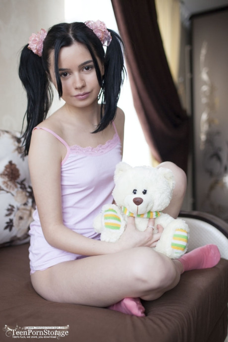 Charming young Rozie shows her tight slit after putting down her plush toy