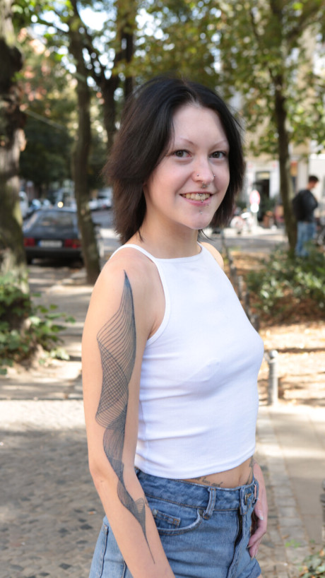 Tattooed German skank GF lady sports a ass plug while posing in the naked