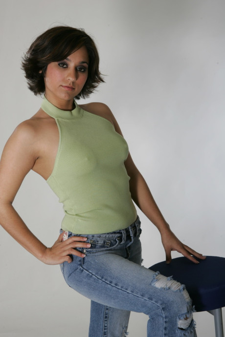 Fine brunette model Shandra posing in her provocative outfits in a solo