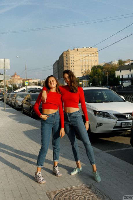 Attractive models in red sweaters Disha & Alevtina Batman show their asses together