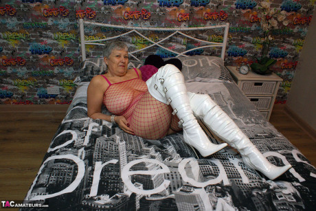 Bold grandmother Savana in thigh poses in fishnet body stocking & thigh high boots