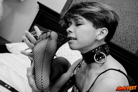 Skinny babe Jett does a charming striptease in her fetish wear on her bed