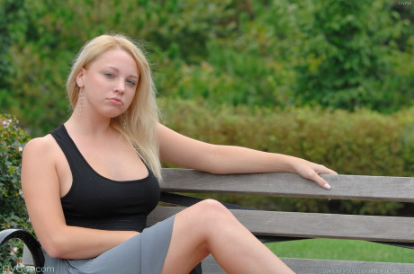 Luscious blonde Crystal flashing her natural breasts and bald cunt in public