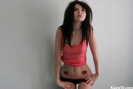 Thin teen Kaira 18 shows her new tattoos while getting naked on her bed