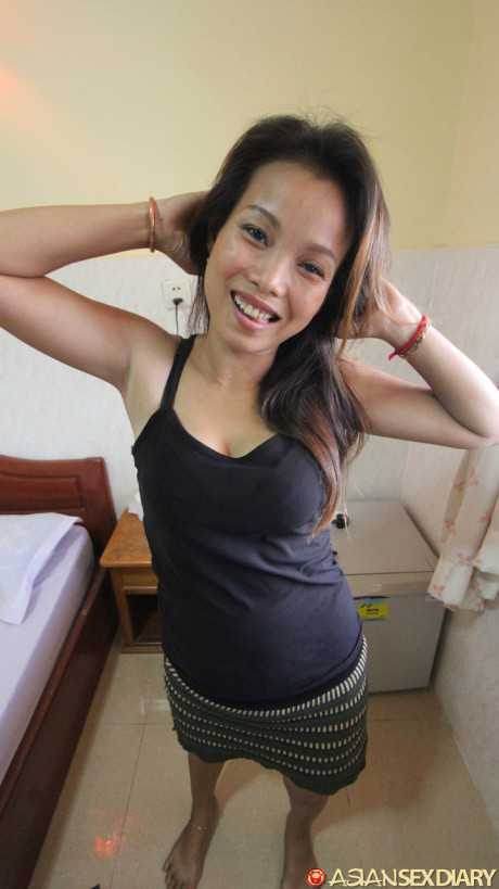 Chinese first timer Sok Neng bangs a small penis on a bed during a POV scene