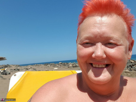 Cougar SSBBW Val Gasmic dyes her hair red before exposing herself on the beach