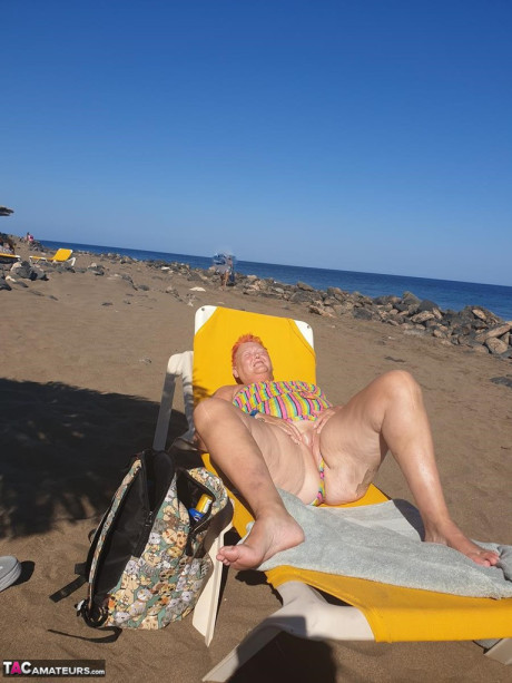 Cougar SSBBW Val Gasmic dyes her hair red before exposing herself on the beach