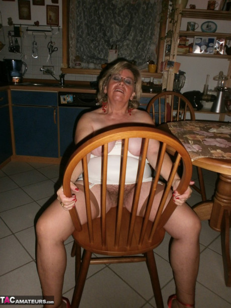 Old yellow-haired Caro exposes her bushy twat while in her galley