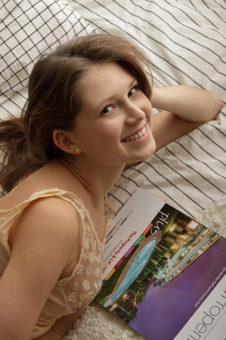 Pretty young amateur Melika slides down her pretty lingerie and masturbates on a bed