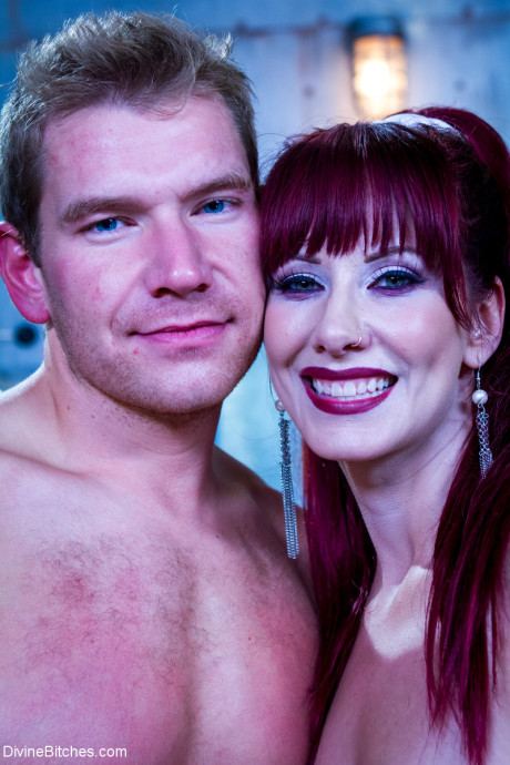 Red Hair domme Maitresse Madeline Marlowe slides a strapon in a dude asshole