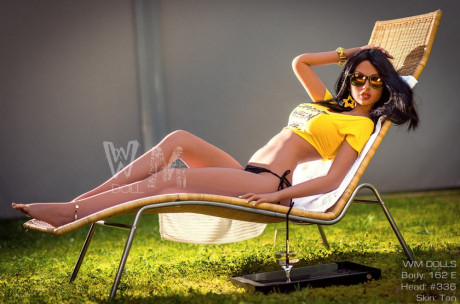 Brunette sex doll Elsa hosing down her wonderful large tits while sunbathing