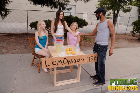Sleazy schoolgirls give their lemonande customer a handjob in public
