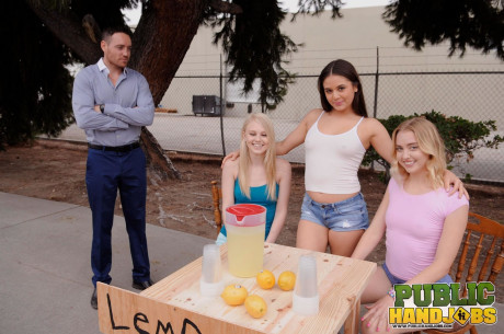 Sleazy schoolgirls give their lemonande customer a handjob in public