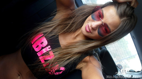 Slim babe with a shaved cunt Melena Tara takes nude self shots in a car