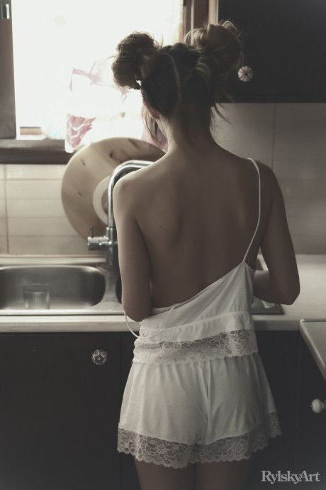 Young young cutie Nedda twerks while mostly nude in a cuisine sink