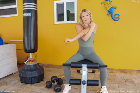 Yellow-haired hottie Becky shows her small tan lined boobs from athletic wear