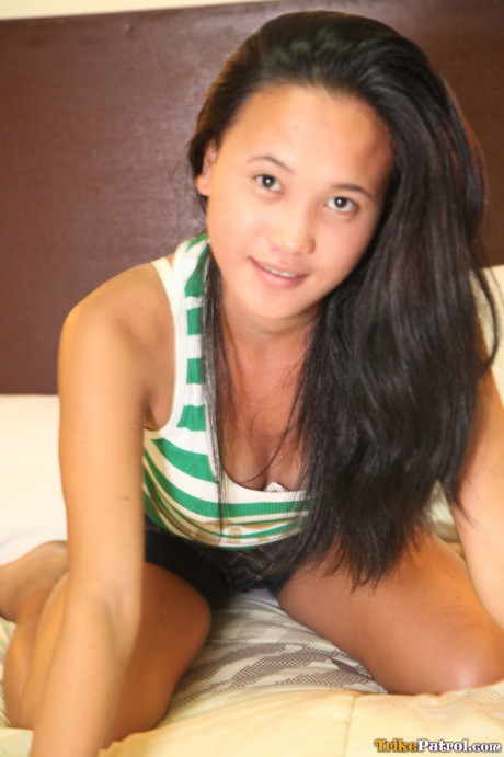 Oriental young Ladylyne exposes her fine snatch & natural titties in a attractive striptease
