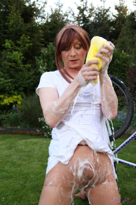 Fine Lucimay gets very soapy as she cleans her bike