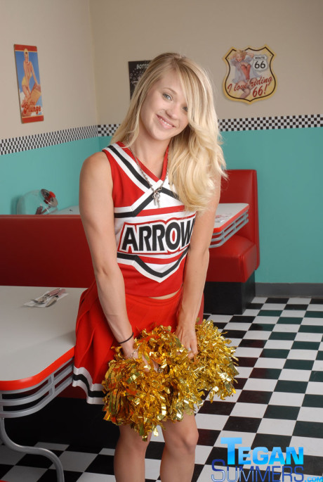 Sweet college blondy Tegan Summers poses in a cheerleader outfit at a diner