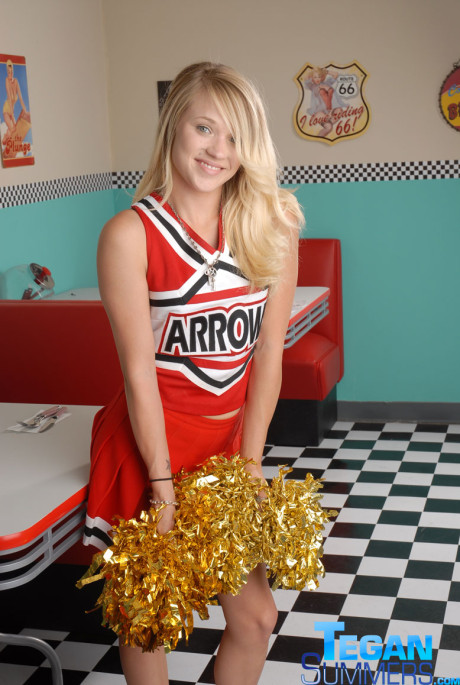 Sweet college blondy Tegan Summers poses in a cheerleader outfit at a diner