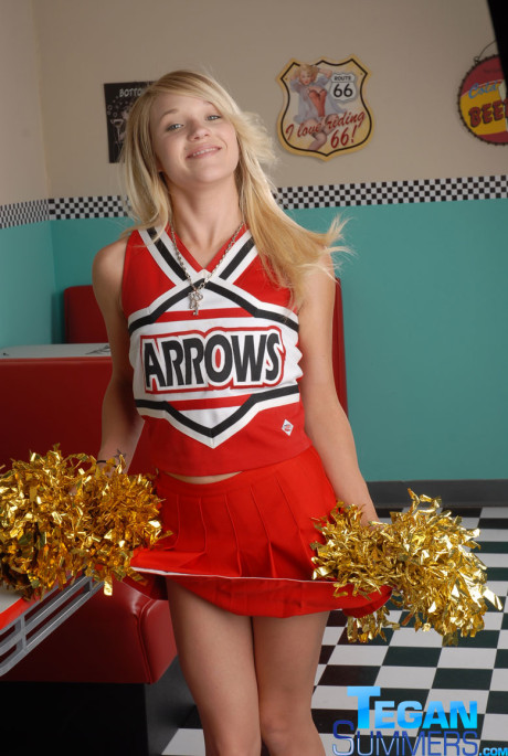 Sweet college blondy Tegan Summers poses in a cheerleader outfit at a diner