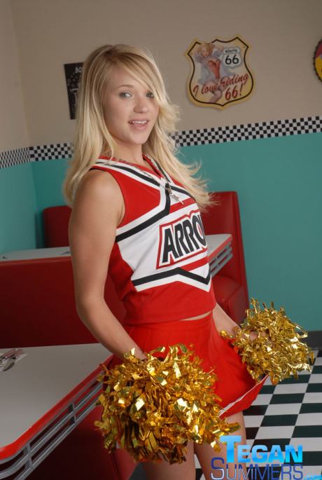 Sweet college blondy Tegan Summers poses in a cheerleader outfit at a diner