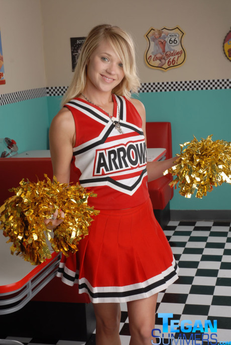 Sweet college blondy Tegan Summers poses in a cheerleader outfit at a diner