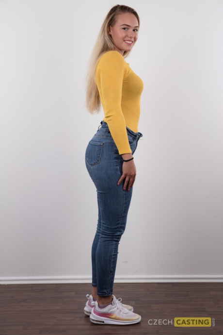 Fully clothed 18 year cougar Silvie stands behind undressed after removing her clothes