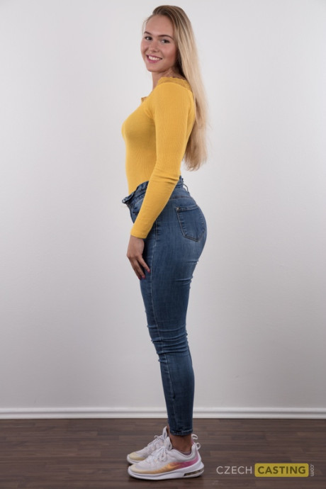 Fully clothed 18 year cougar Silvie stands behind undressed after removing her clothes