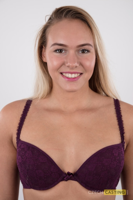 Fully clothed 18 year cougar Silvie stands behind undressed after removing her clothes
