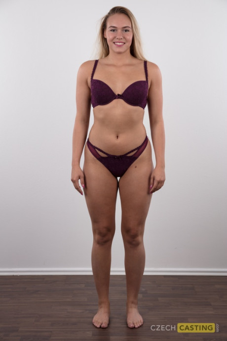 Fully clothed 18 year cougar Silvie stands behind undressed after removing her clothes