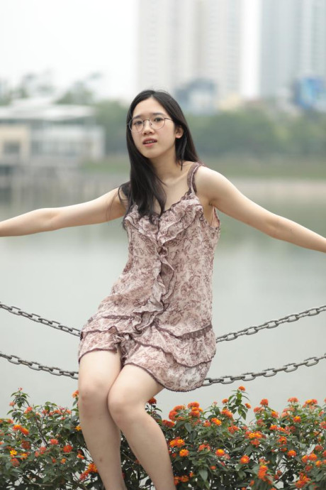 Good-looking chinese sexpot teases in a lovely short dress outdoors