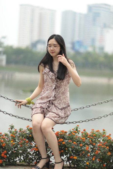 Good-looking chinese sexpot teases in a lovely short dress outdoors