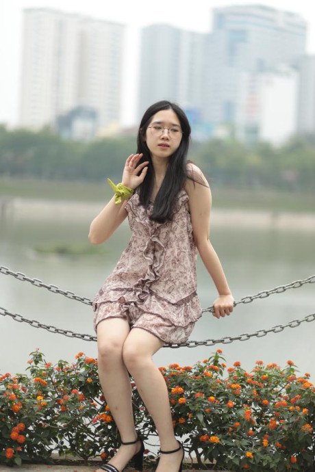 Good-looking chinese sexpot teases in a lovely short dress outdoors