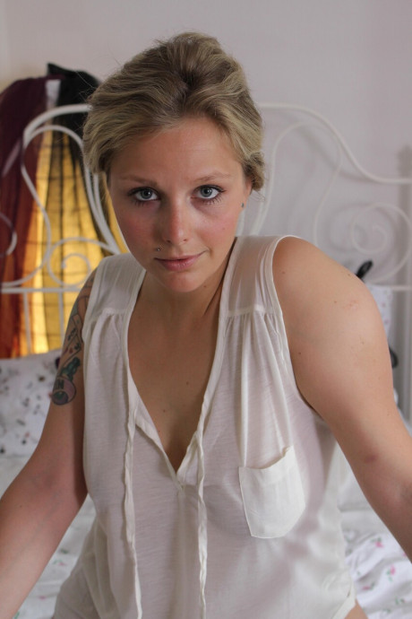 Tattooed amateur shows her big behind and plays with her shaved vagina