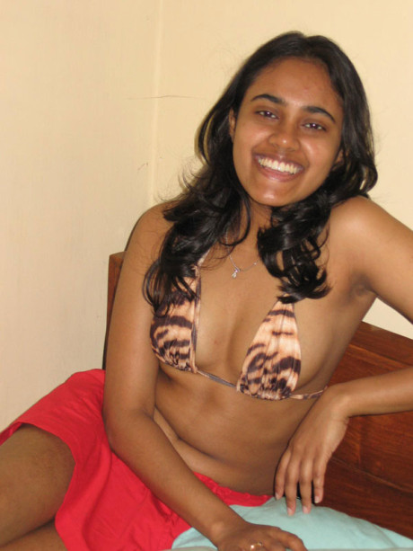 Indian lady GF lady with a nice smile shows her boobies on top of a bed