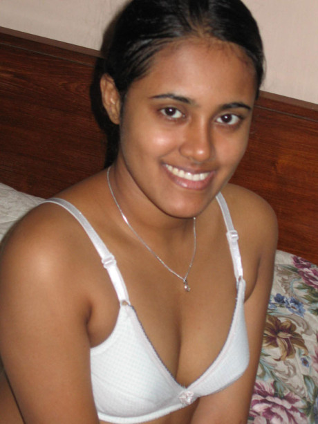 Indian lady GF lady with a nice smile shows her boobies on top of a bed