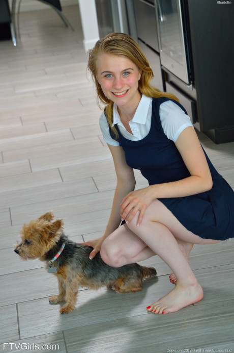 Tiny schoolgirl Sharlotte in uniform bends over for a nude upskirt outside