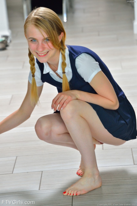 Tiny schoolgirl Sharlotte in uniform bends over for a nude upskirt outside