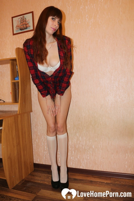 Mature brunette poses in knee socks and teases with her fabulous figure