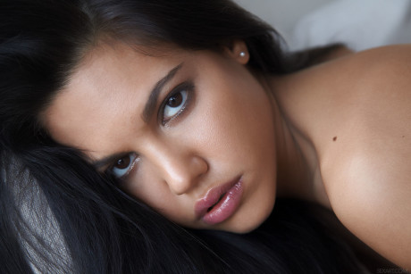 Dark-haired young Apolonia exposes her body and touches her trimmed vagina