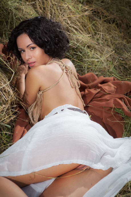 Ravishing young Pammie Lee unveils her amazing huge titties and poses in the hay
