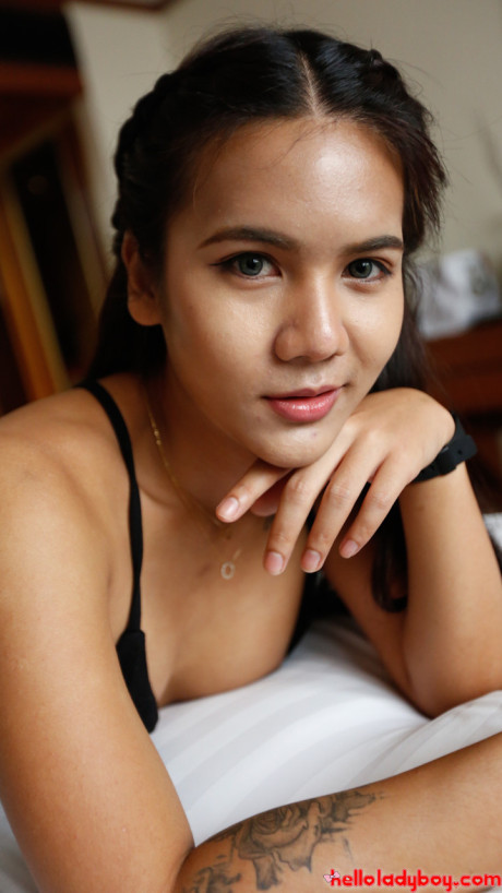Brunette chinese teenie Tess B shows her humongous titties and poses in a hotel room