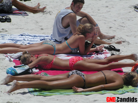 Hot tanned chicks butt in tight bikinis at the beach