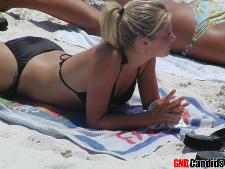 Hot tanned chicks butt in tight bikinis at the beach