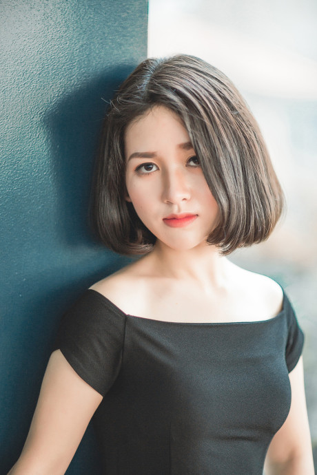 Glamorous chinese babe posing in her elegant ebony dress in public