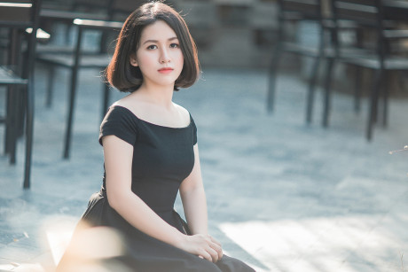 Glamorous chinese babe posing in her elegant ebony dress in public